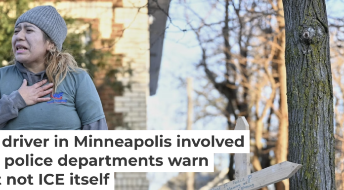 A protester stands near a makeshift memorial honoring Renee Nicole Good, the victim of a fatal shooting in Minneapolis involving federal law enforcement agents. AP Photo/Tom Baker